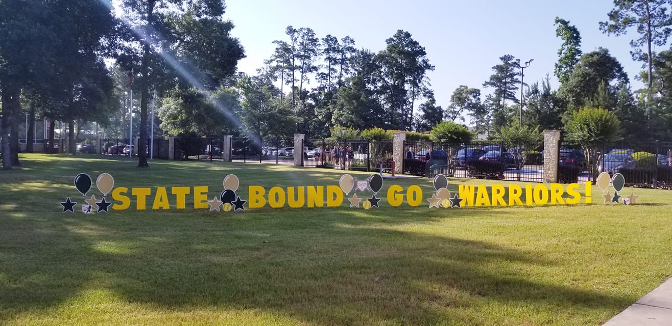 The Woodlands High School sports team celebrating the playoffs with custom yard card graphics in team colors, The Woodlands, TX.