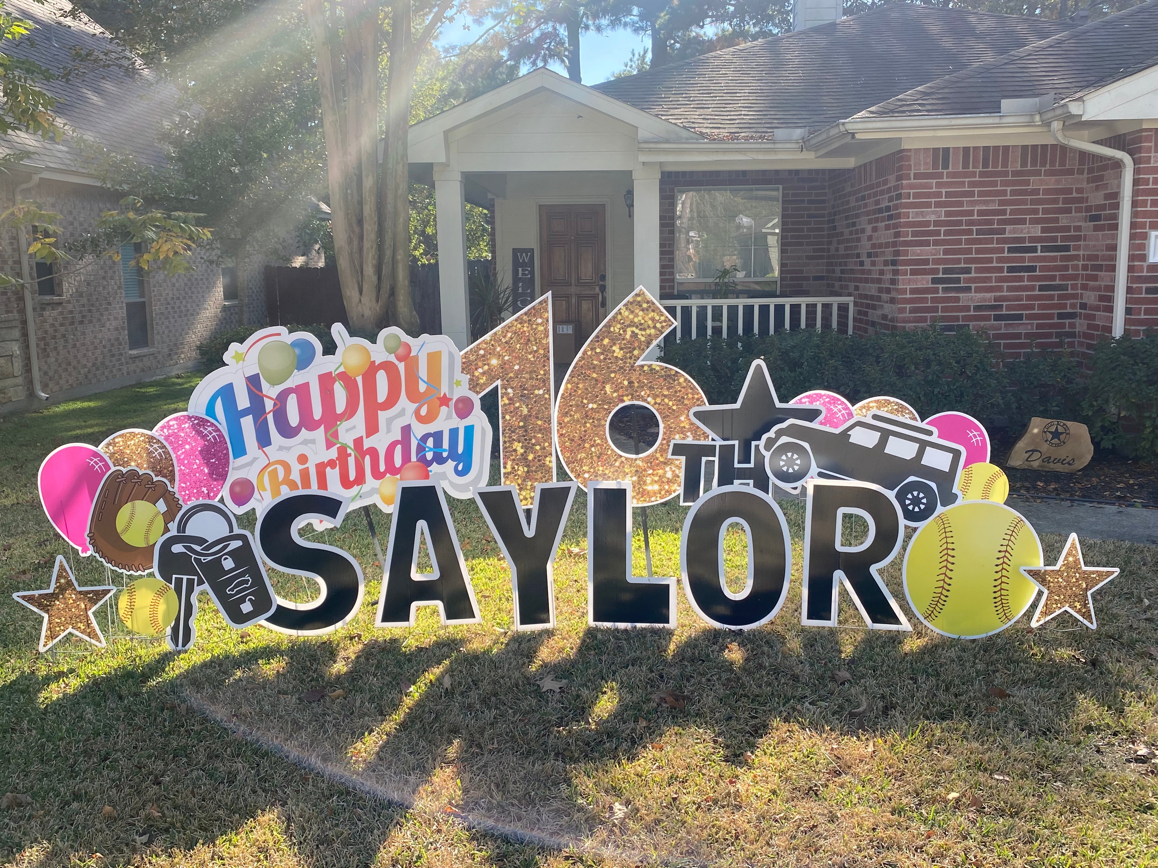 A stylish yard card display by Texas Party in the Yard, celebrating a girl's 16th birthday. The setup features a "Sweet 16" message with her name, glittery stars, high heels, and colorful balloons, creating a glamorous celebration in Montgomery, TX.